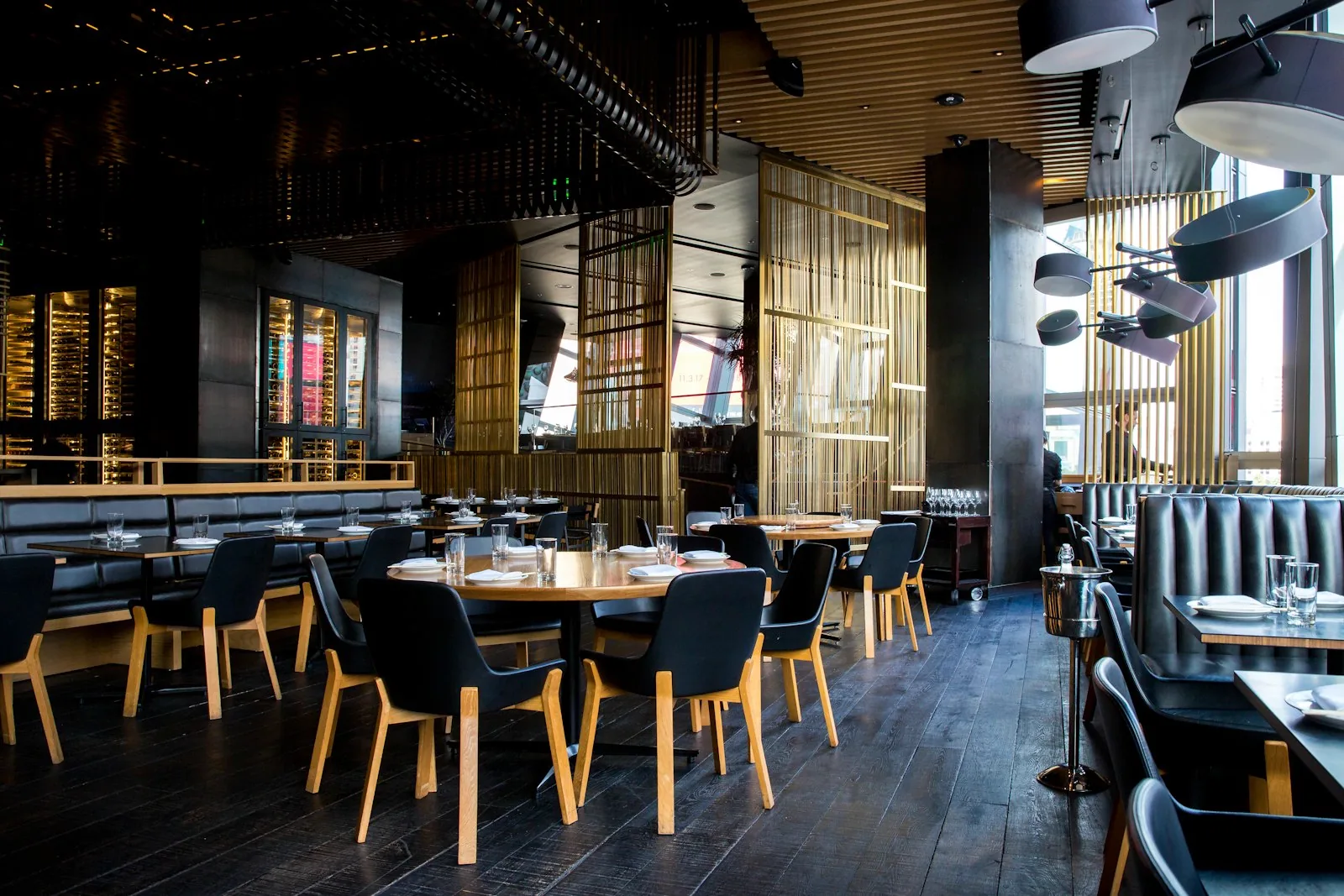 Candle-lit restaurant dining room, dark wood and warm light